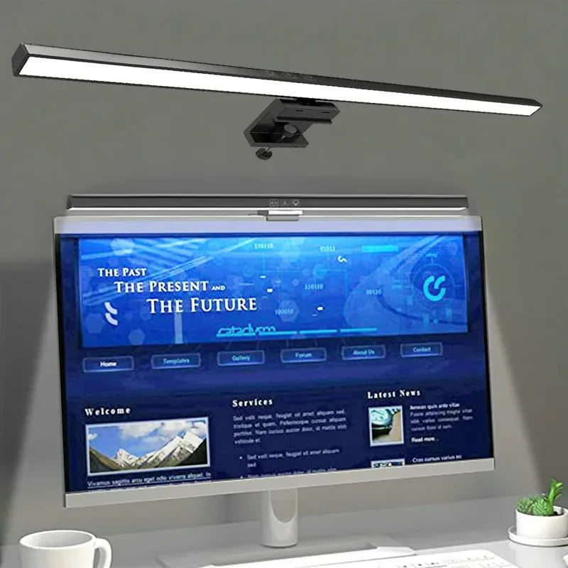 Monitor light bar illuminating a desktop workspace